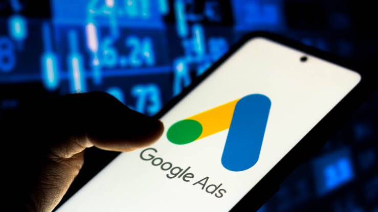 A smartphone displaying the Google Ads logo, representing PPC advertising, online campaigns, and business lead generation through Google Ads.